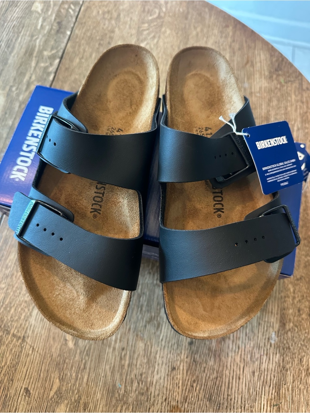 Birkenstock Arizona women’s Black Two-strap Sandals with Brown Footbed